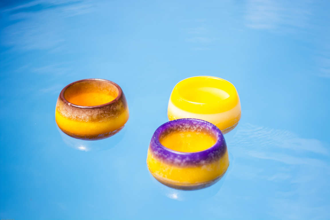 Tres cuencos de parafina de color amarillo flotando en piscina